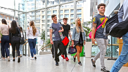 Students walking through the NCI atrium